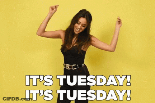 A Woman Is Dancing In Front Of A Yellow Background With The Words It 'S Tuesday GIF