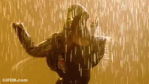 A Woman Is Dancing In The Rain While Wearing A Black Jacket . GIF