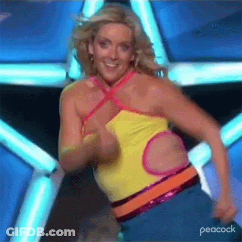 A Woman Is Dancing On A Stage With A Peacock Logo In The Corner . GIF