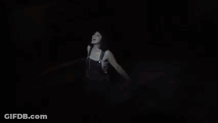 A Woman Is Dancing On A Stage With A Sword In Her Hand GIF