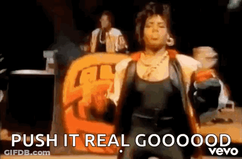 A Woman Is Dancing On A Stage With The Words `` Push It Real Goooood '' . GIF