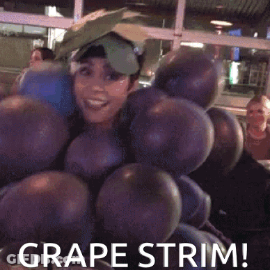 A Woman Is Dressed As A Bunch Of Grapes And Says Grape Trim GIF