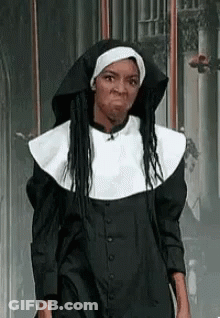 A Woman Is Dressed As A Nun And Making A Face . GIF