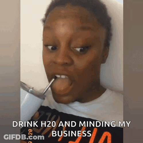 A Woman Is Drinking H2o Through A Straw And Minding Her Business GIF