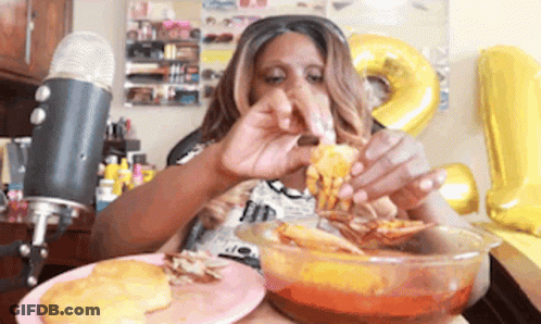 A Woman Is Eating A Bowl Of Food In Front Of A Microphone GIF