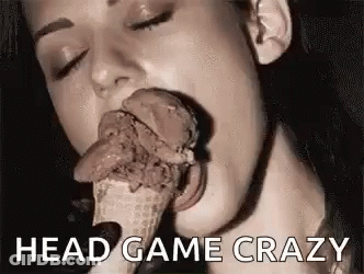 A Woman Is Eating A Chocolate Ice Cream Cone With Her Tongue . GIF