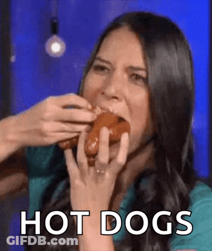 A Woman Is Eating A Hot Dog And The Word Hot Dogs Is On The Bottom GIF