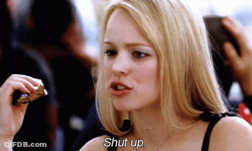 A Woman Is Eating A Piece Of Pizza And Says Shut Up . GIF
