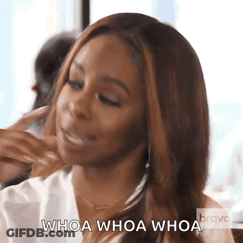A Woman Is Eating A Sandwich And Says Whoa Whoa Whoa . GIF