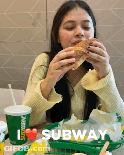 A Woman Is Eating A Subway Sandwich And Drinking A Subway Cup GIF