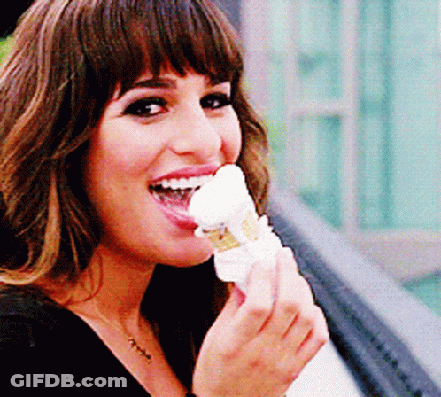 A Woman Is Eating An Ice Cream Cone With Her Tongue Hanging Out GIF