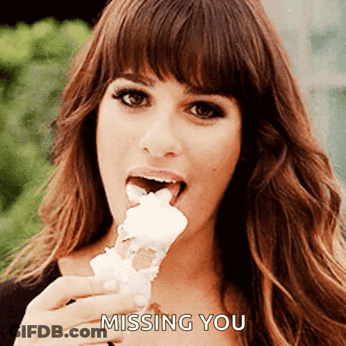 A Woman Is Eating An Ice Cream Cone With The Words " Missing You " On The Bottom GIF
