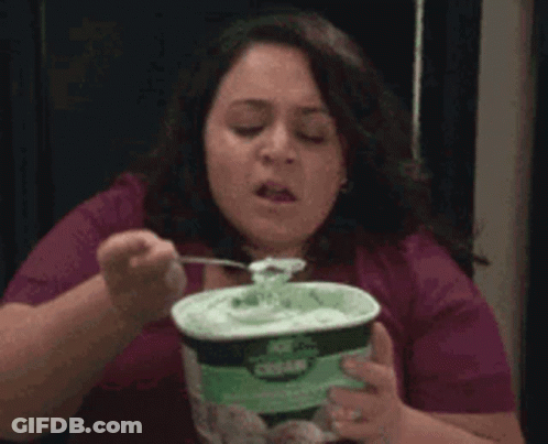 A Woman Is Eating Ice Cream With A Fork GIF