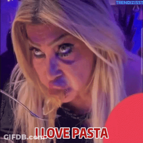 A Woman Is Eating Pasta With A Fork And The Words I Love Pasta Below Her GIF