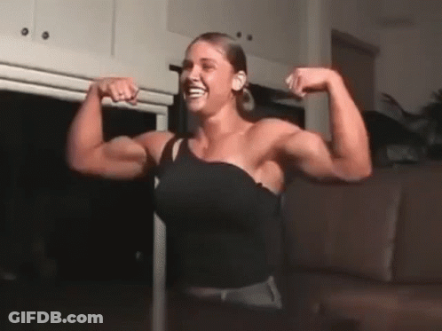Woman Flexing Muscles And Smiling GIF