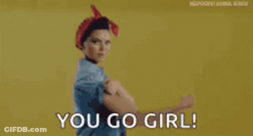 A Woman Is Flexing Her Muscles With The Words `` You Go Girl '' Behind Her . GIF