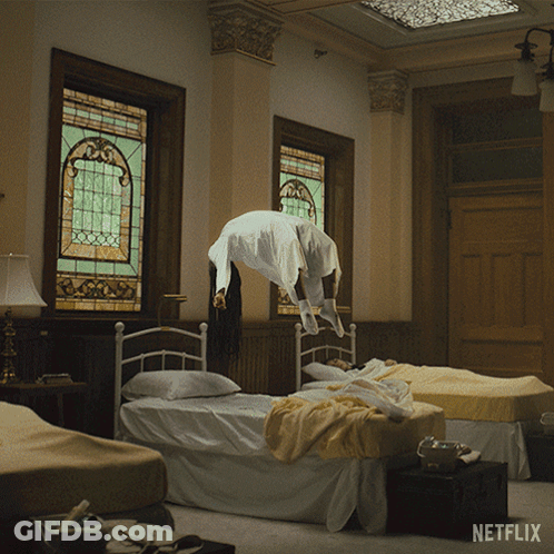 A Woman Is Flying Through The Air In A Room With Netflix Written On The Bottom GIF