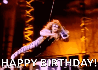 A Woman Is Flying Through The Air On A Rope While Holding A Guitar And Says `` Happy Birthday '' . GIF