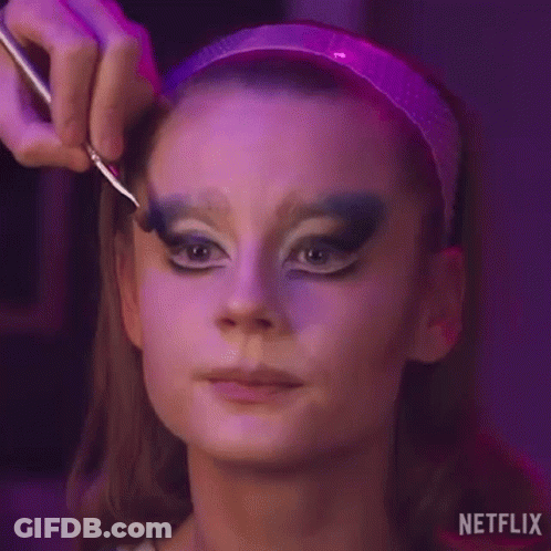 A Woman Is Getting Her Makeup Done By A Makeup Artist With A Brush . GIF