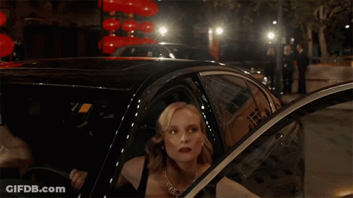 A Woman Is Getting Out Of A Car In Front Of Chinese Lanterns GIF