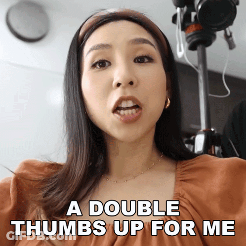 A Woman Is Giving A Double Thumbs Up For Herself GIF