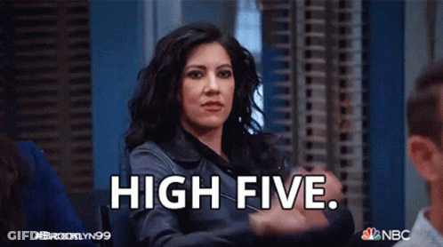 A Woman Is Giving A High Five To Another Woman While Another Woman Looks On . GIF