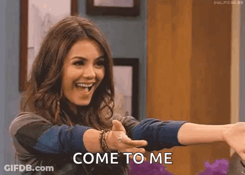 A Woman Is Giving A Thumbs Up And Smiling While Holding Out Her Arms And Saying Come To Me . GIF