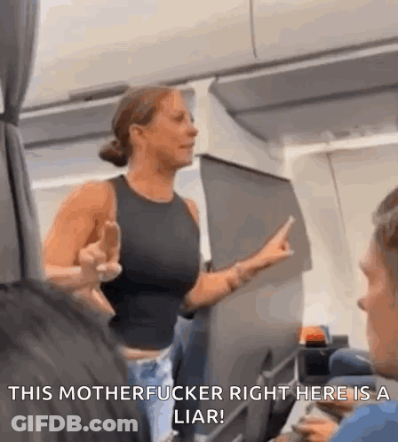 A Woman Is Giving The Middle Finger On An Airplane While Talking To A Man . GIF
