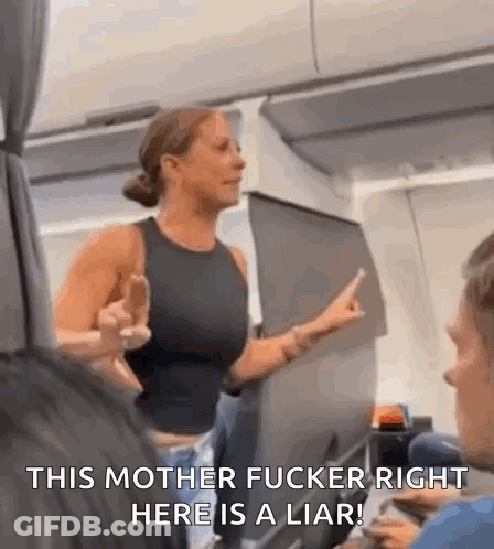 A Woman Is Giving The Middle Finger On An Airplane While Talking To A Man . GIF