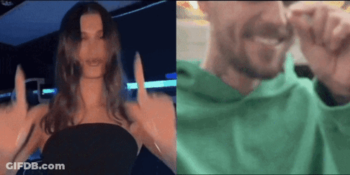 A Woman Is Giving The Middle Finger To A Man In A Green Sweatshirt . GIF