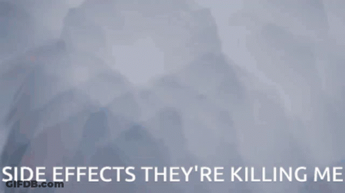 A Woman Is Hanging Upside Down With The Words Side Effects They 'Re Killing Me Behind Her GIF