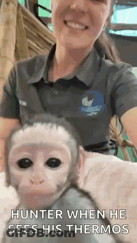 A Woman Is Holding A Baby Monkey With The Caption Hunter When He Sees His Thermos . GIF