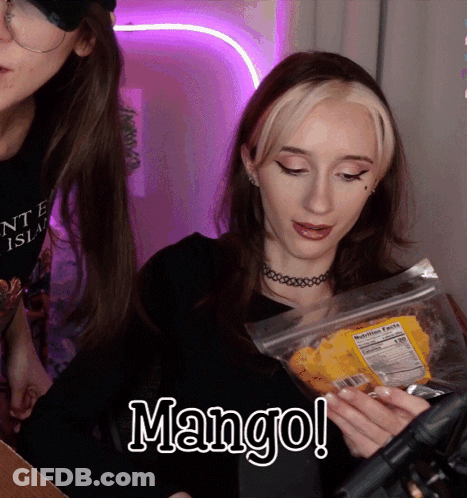 A Woman Is Holding A Bag Of Mango Chips In Her Hands GIF