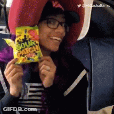 A Woman Is Holding A Bag Of Patch Candy And Smiling GIF