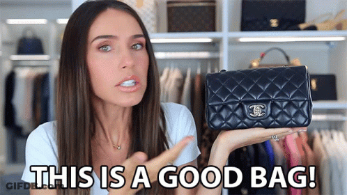 A Woman Is Holding A Black Chanel Purse And Says " This Is A Good Bag " GIF