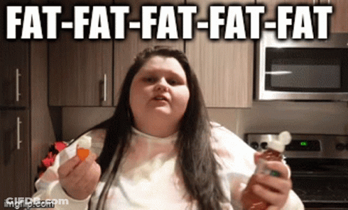 A Woman Is Holding A Bottle Of Hot Sauce And A Slice Of Bread With The Caption Fat-Fat-Fat GIF