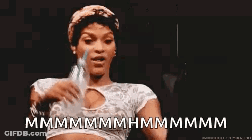 A Woman Is Holding A Bottle Of Water In Her Hand And Making A Face . GIF