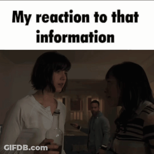 A Woman Is Holding A Bottle Of Wine And Talking To Another Woman GIF