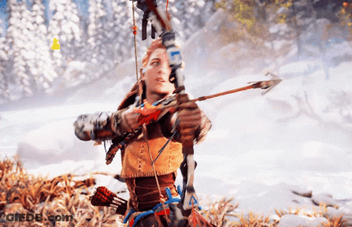 A Woman Is Holding A Bow And Arrow In A Snowy Forest GIF