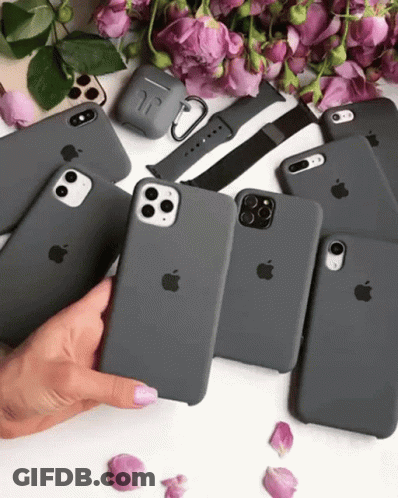 A Woman Is Holding A Bunch Of Apple Phones GIF