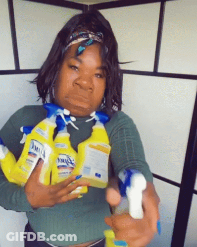 A Woman Is Holding A Bunch Of Clorox Spray Bottles In Her Hands GIF
