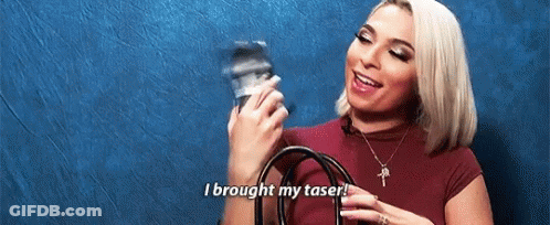 A Woman Is Holding A Camera And Saying `` I Brought My Taser ! '' GIF