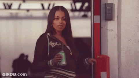 A Woman Is Holding A Can Of Soda And Wearing A Hoodie That Says Rica GIF