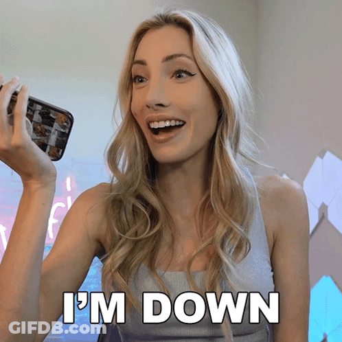 A Woman Is Holding A Cell Phone And Says " I 'M Down " In White Letters GIF