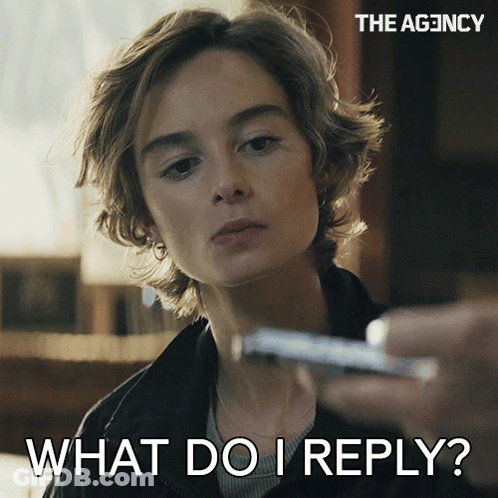 A Woman Is Holding A Cell Phone And Says " What Do I Reply " On The Bottom GIF