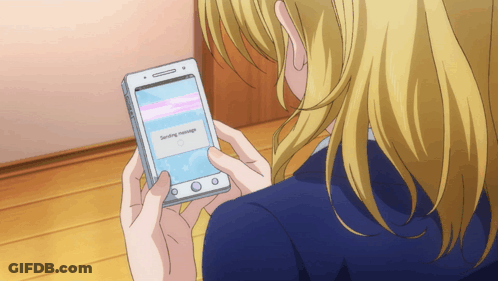 A Woman Is Holding A Cell Phone That Says Sending Message On The Screen GIF