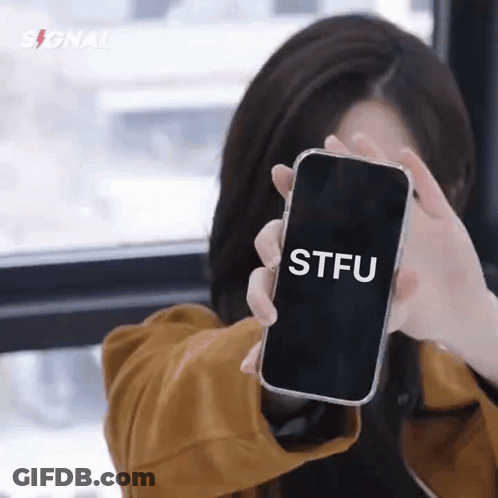 A Woman Is Holding A Cell Phone That Says Stfu On It GIF
