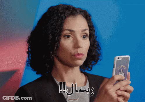 A Woman Is Holding A Cell Phone With A Sticker That Says Pm GIF