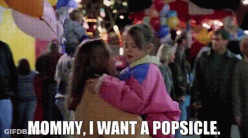A Woman Is Holding A Child In Her Arms And Says Mommy I Want A Popsicle GIF