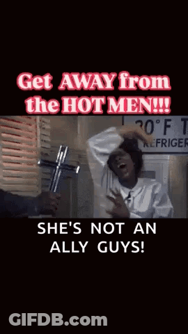 A Woman Is Holding A Cross In Front Of A Sign That Says Refrigerator GIF